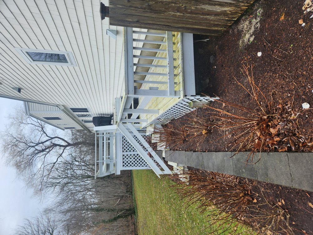 Old Worn Out decks with bushes and small deck blocking path to outdoor shower